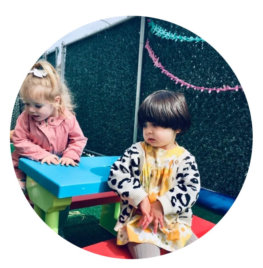 Two children playing with a small table