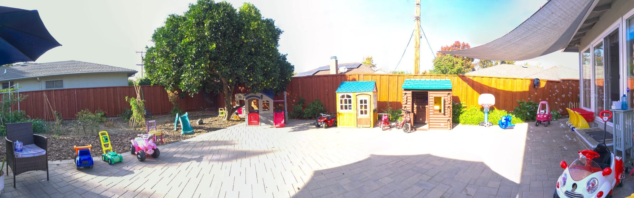 Outdoor play area with playhouses and various toys