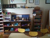 Classroom with shelves of learning materials and small chairs