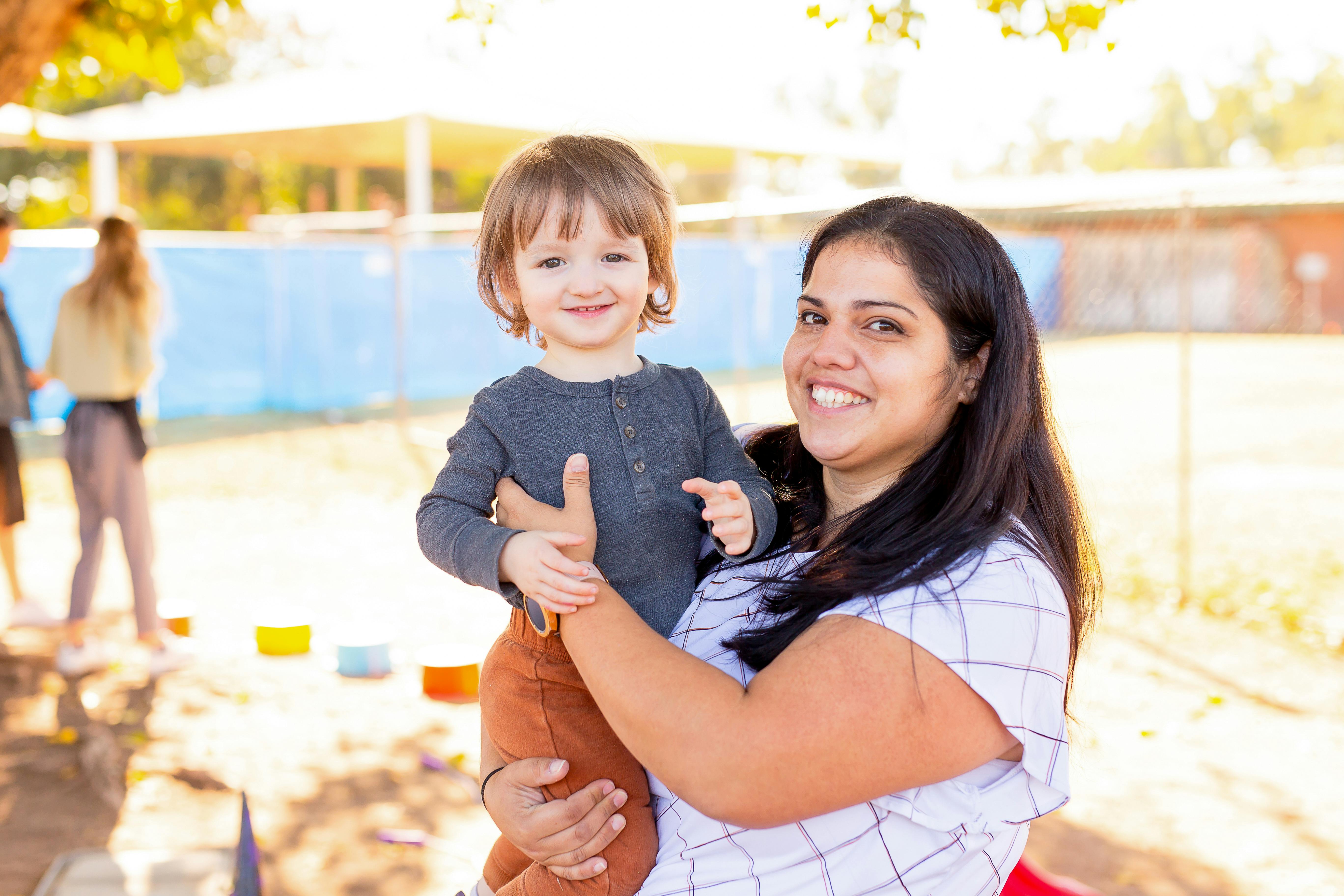 Adult holding a child in an outdoor setting