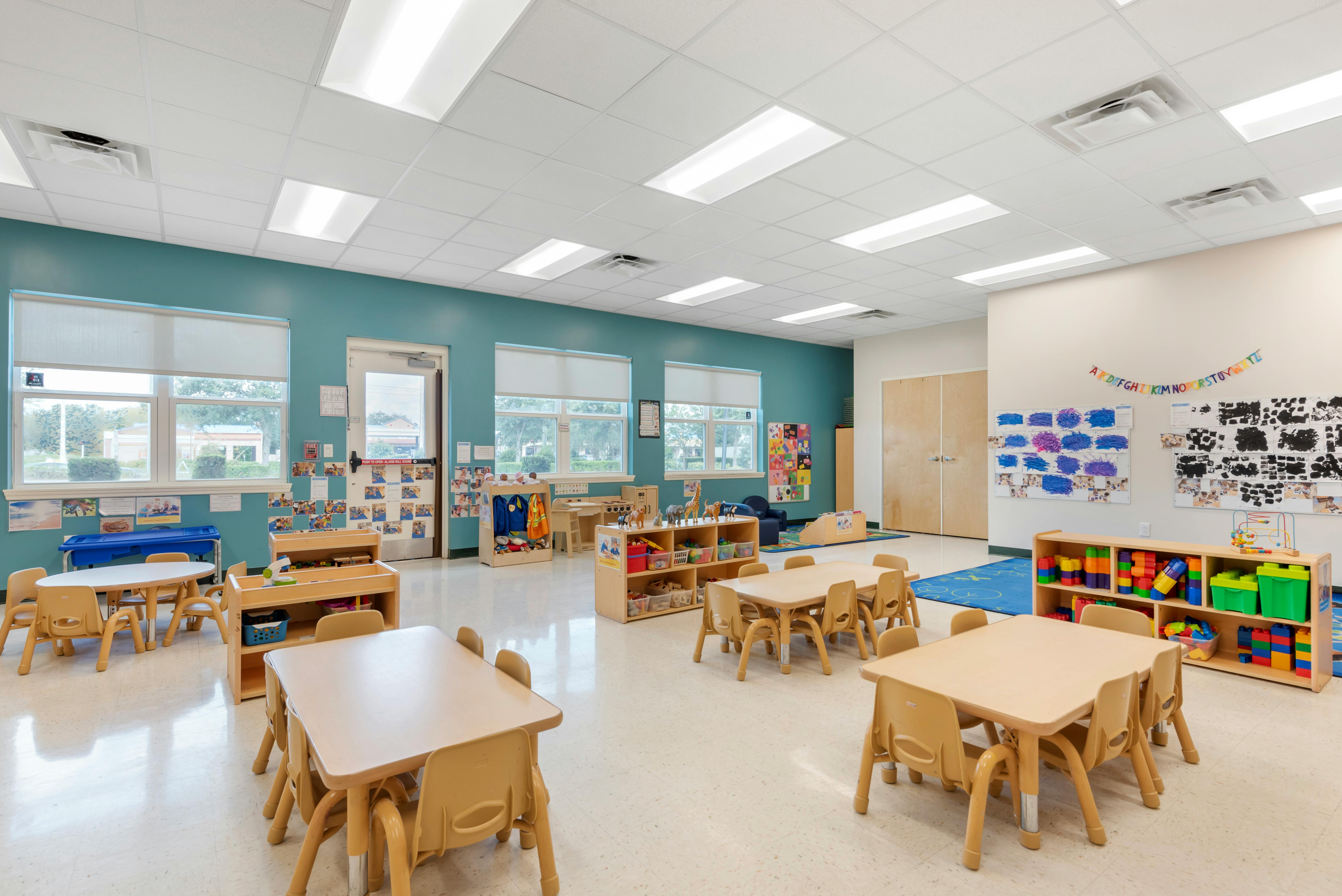 Empty classroom with small tables and chairs