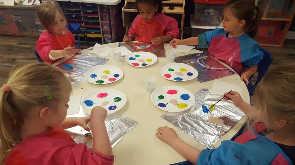Children painting at a table