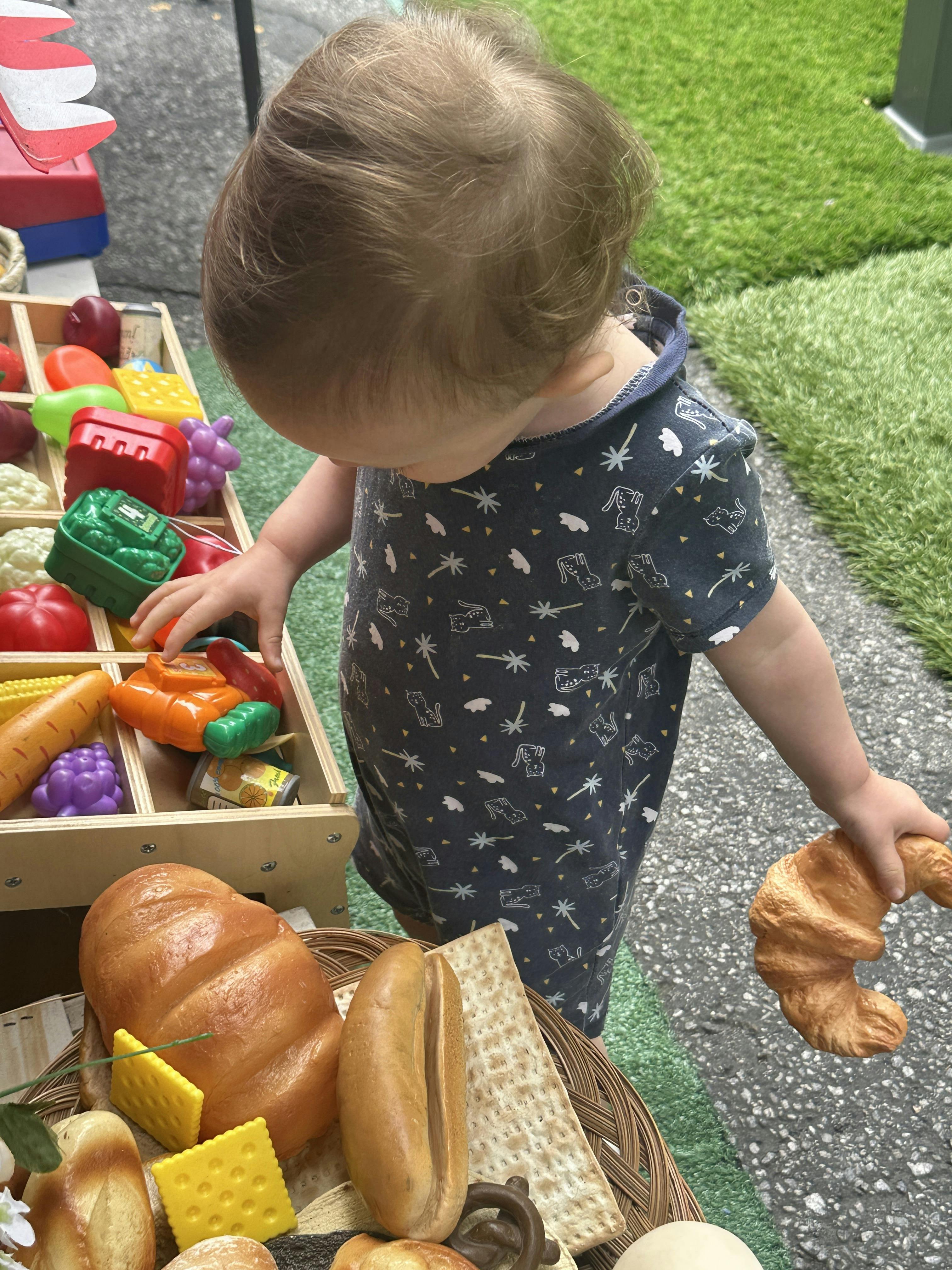 Child playing with toy food items