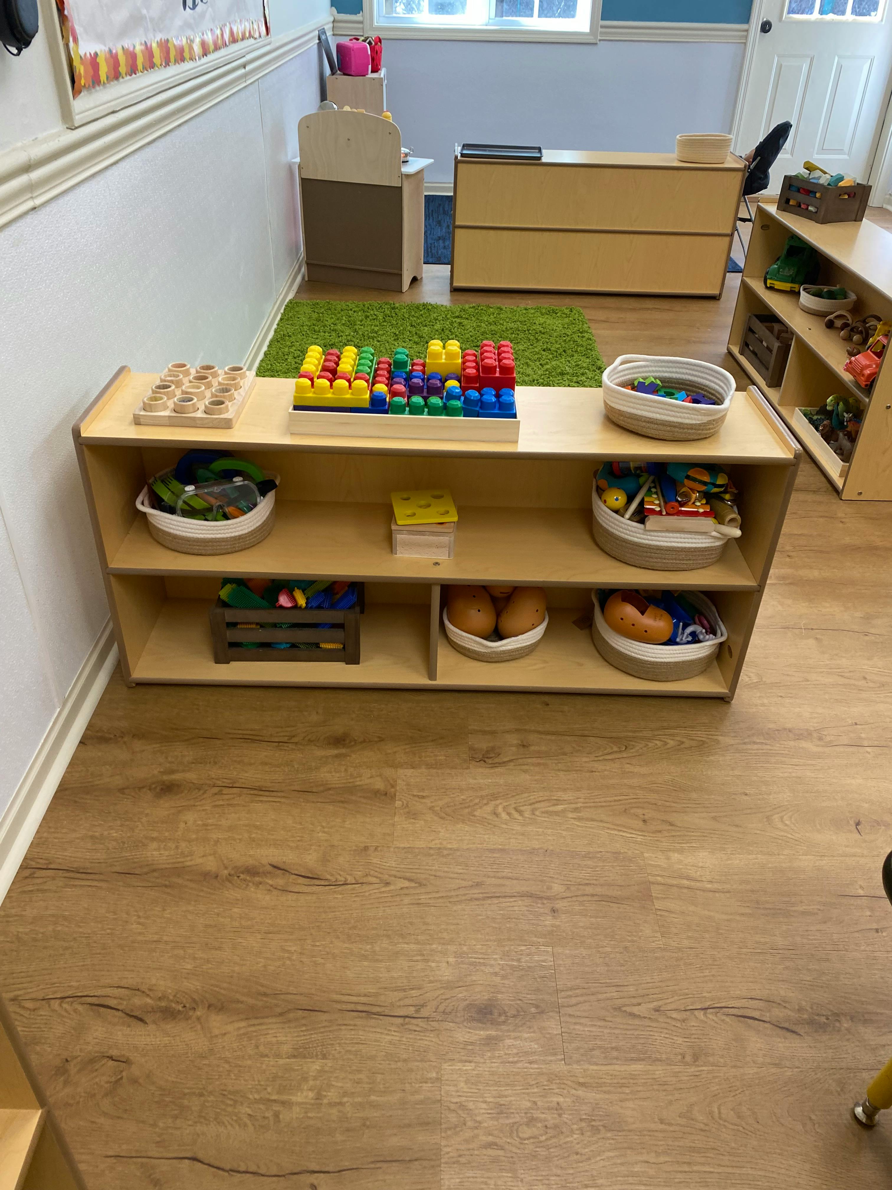 Children's classroom with wooden toy shelves and colorful toys