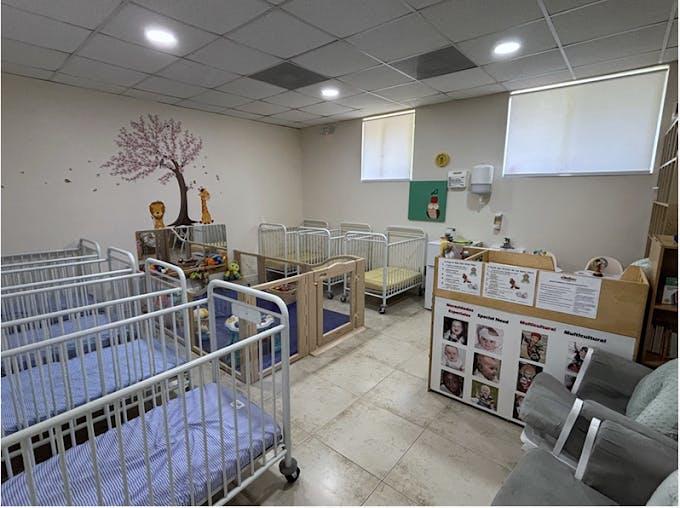 Room with multiple cribs and playpens