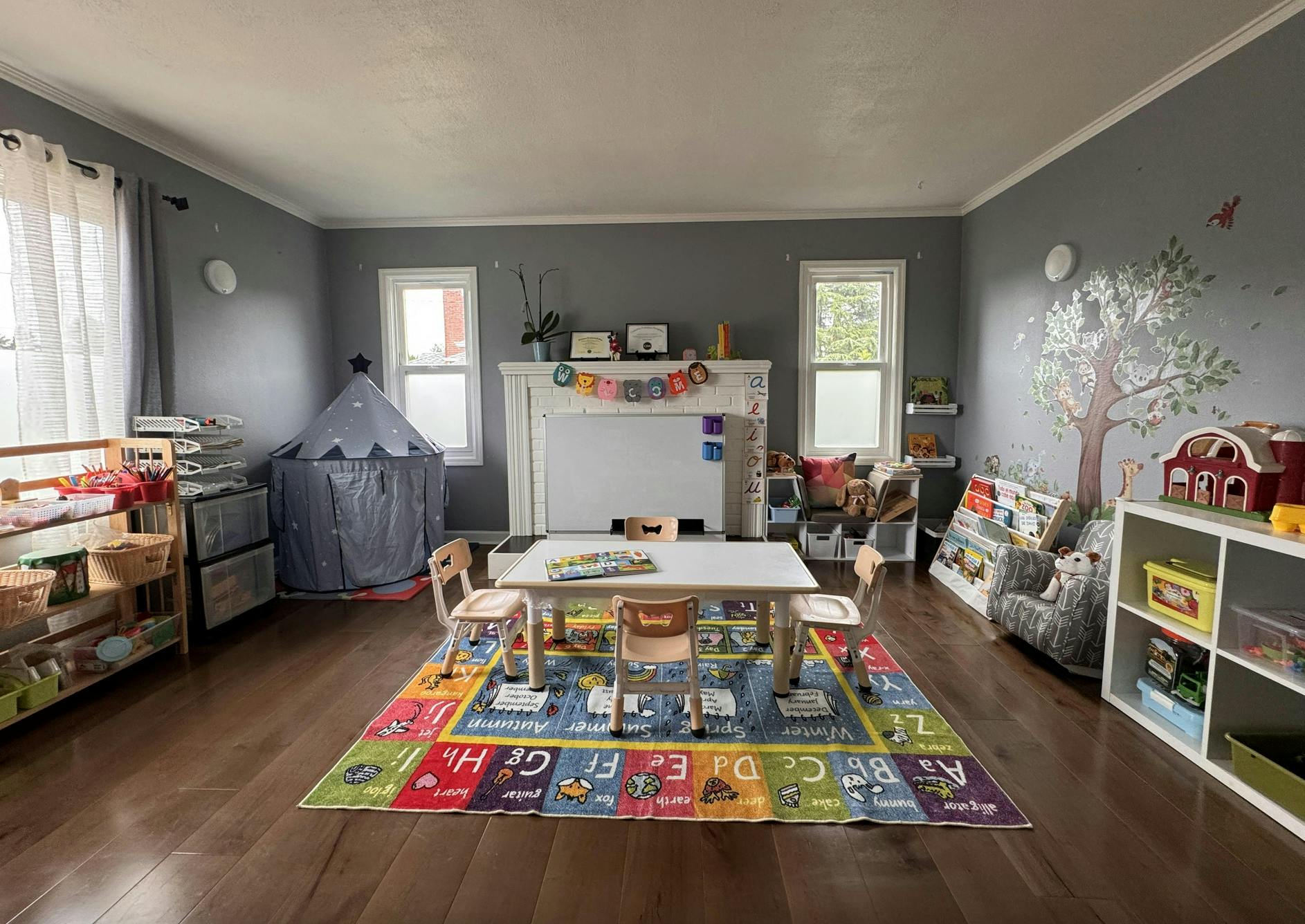 Child's playroom with small table and chairs on an alphabet rug