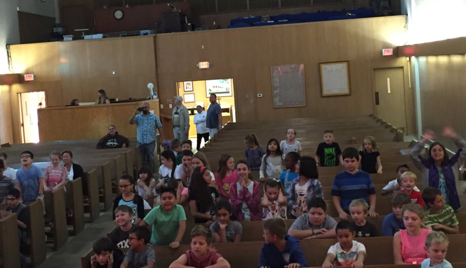 Group of children and adults in an auditorium