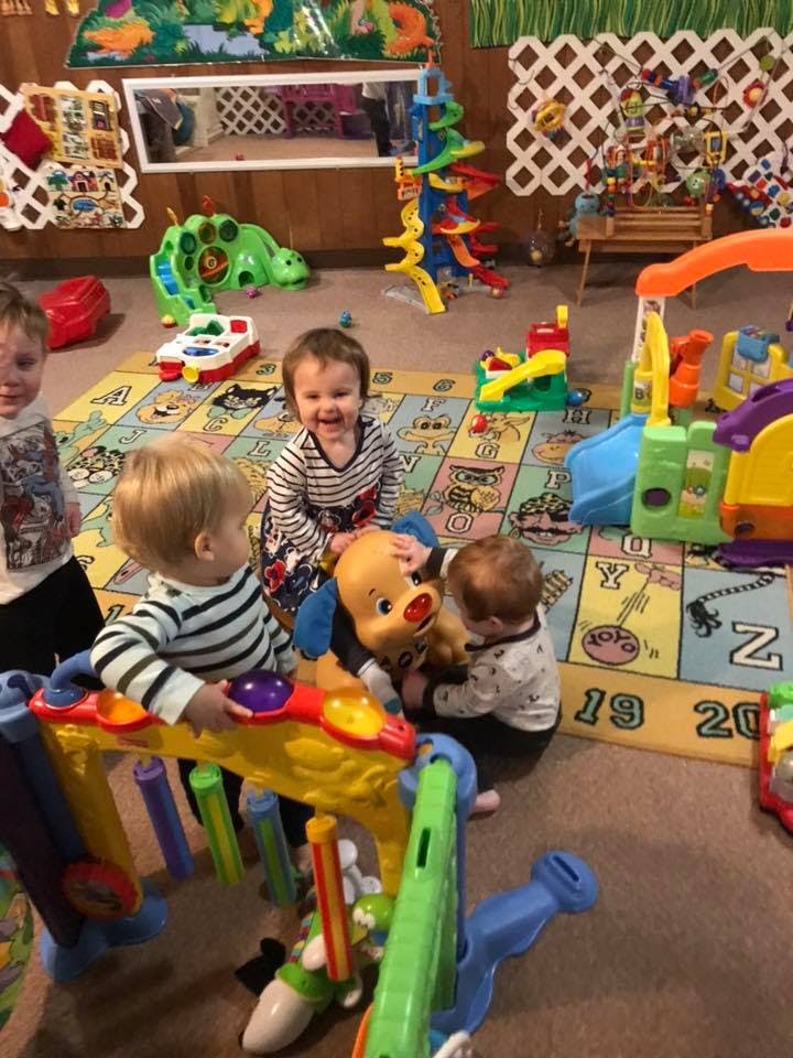 Three children playing with toys in a room