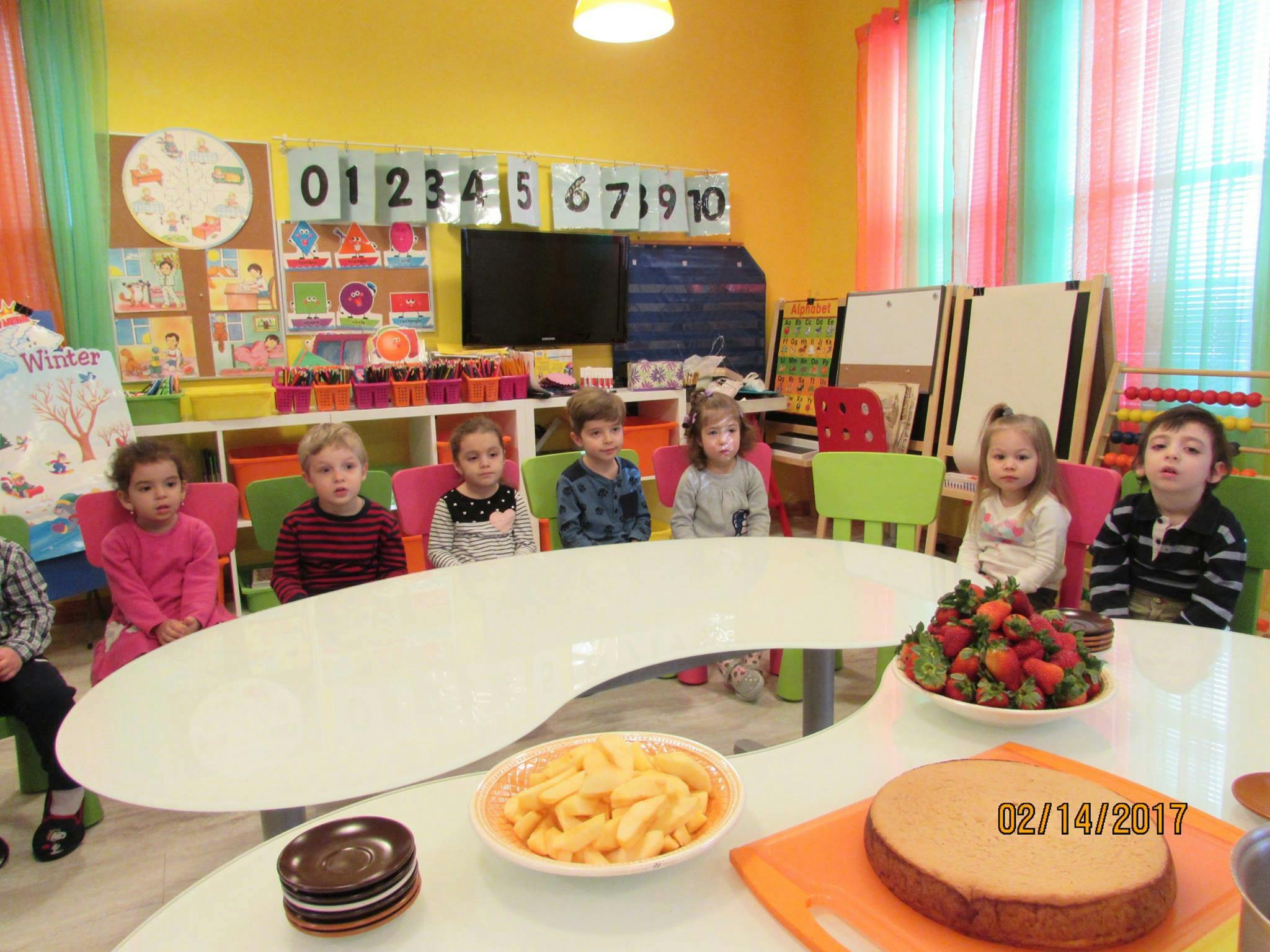 Children sitting at a table in a classroom