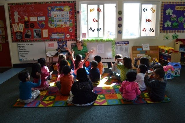 Person teaching a group of children in a classroom