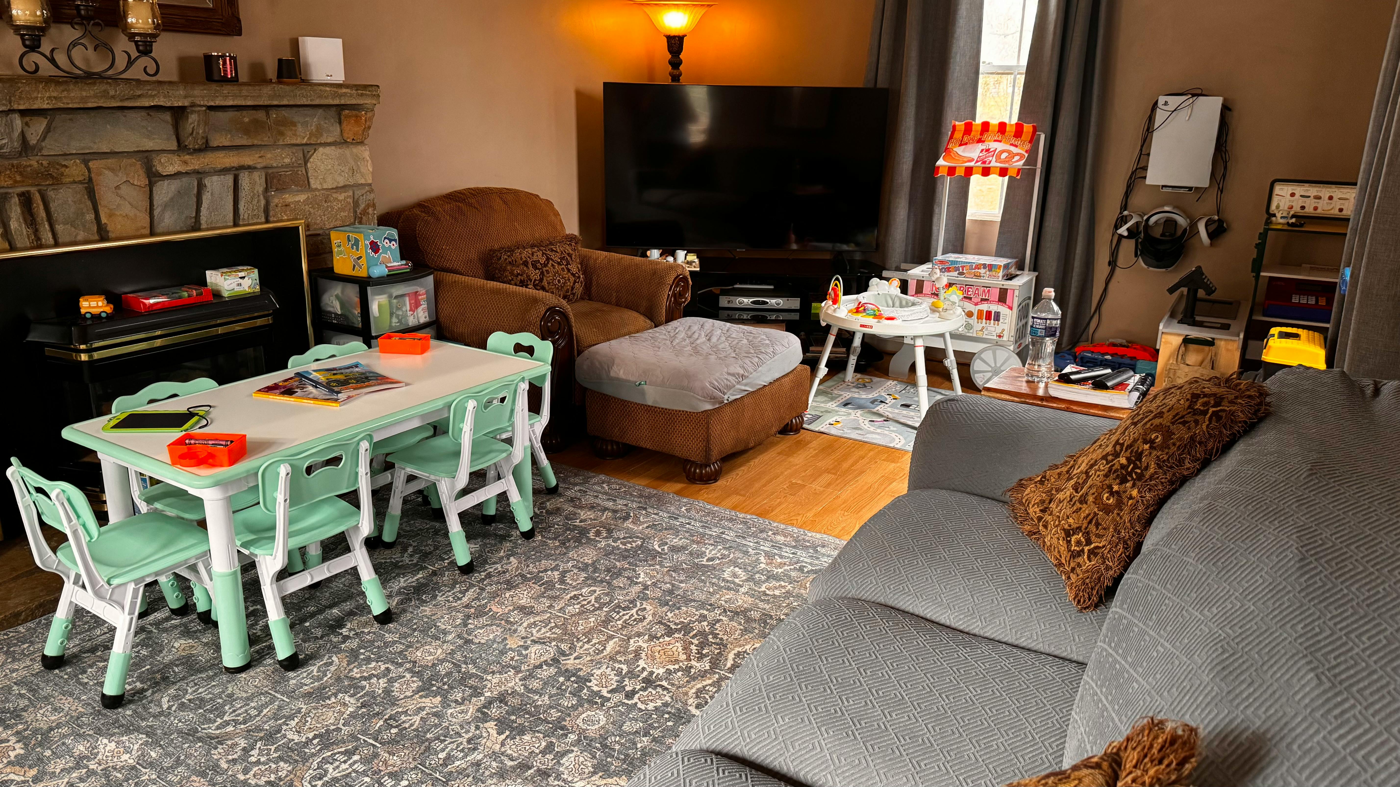 Living room with a small table and chairs, sofa, and television