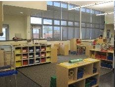 Empty classroom with shelves and large windows