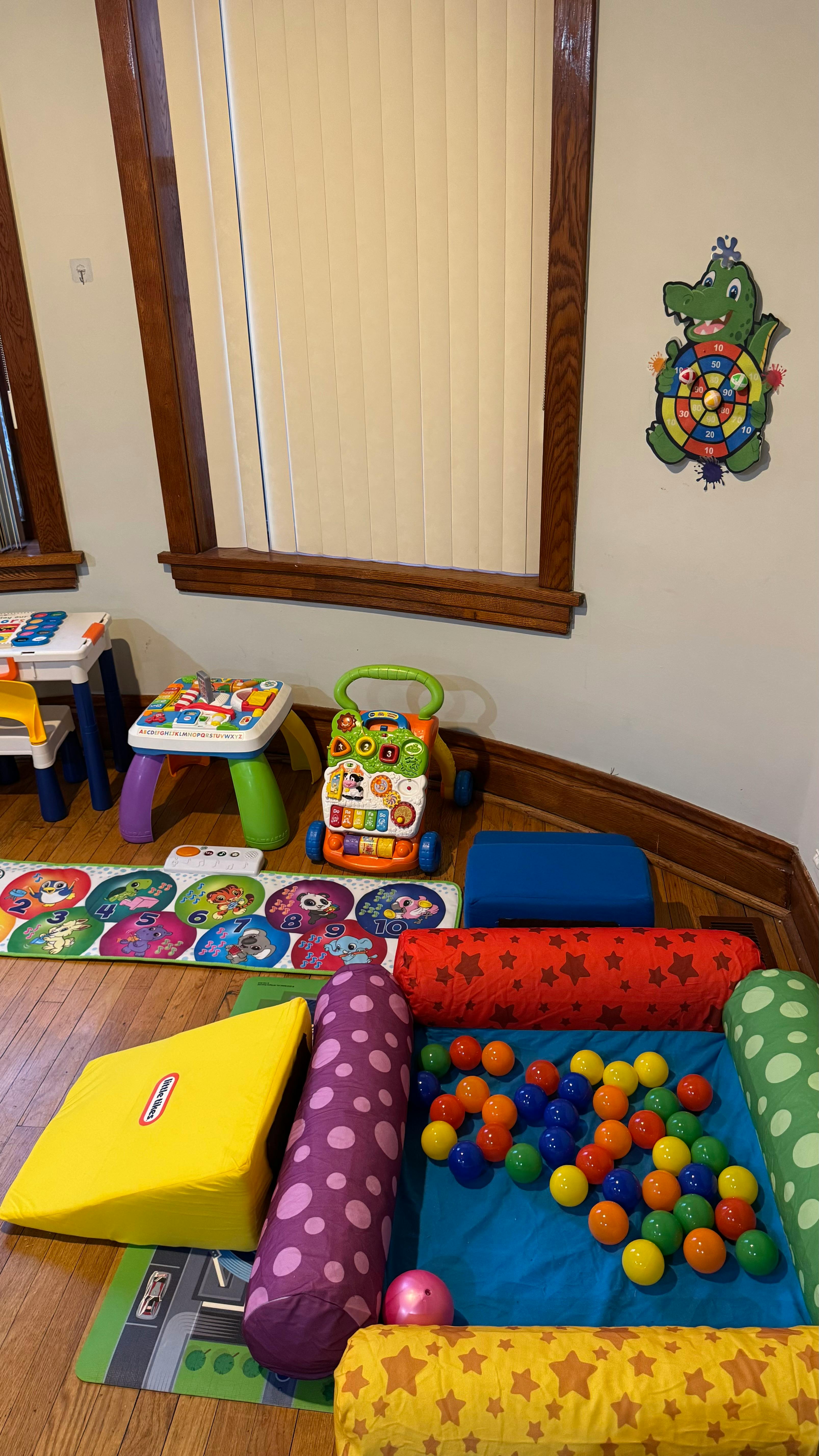 Playroom with soft play equipment, ball pit, and toys