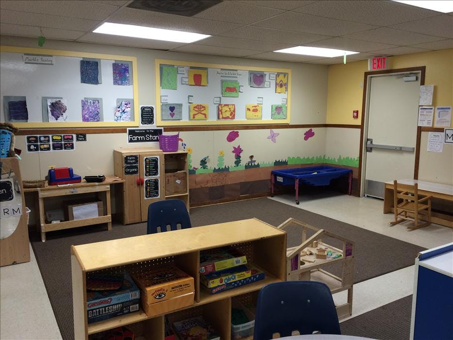 Empty classroom with student artwork on the wall and various learning stations
