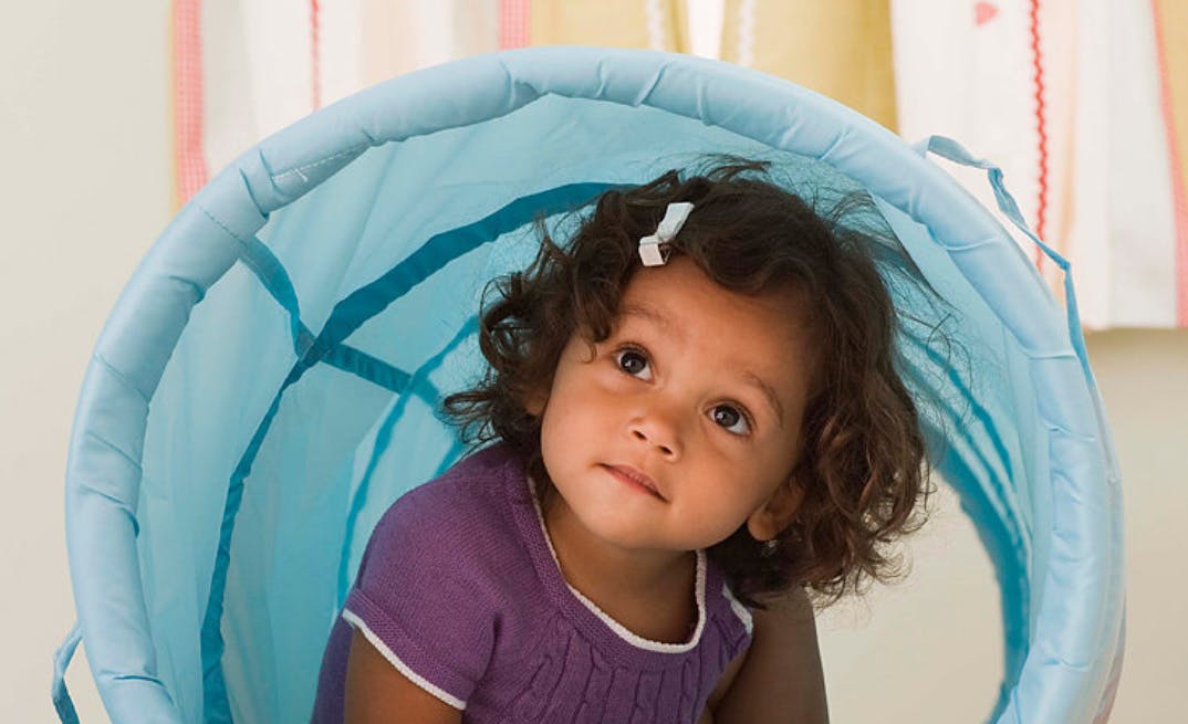 Child in a blue play tunnel