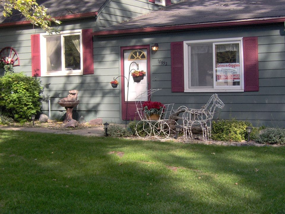 Front of a house with a decorative horse and carriage