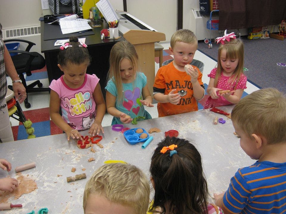 Children playing with modeling clay at a table