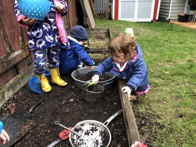 Children playing in dirt with pots and pans