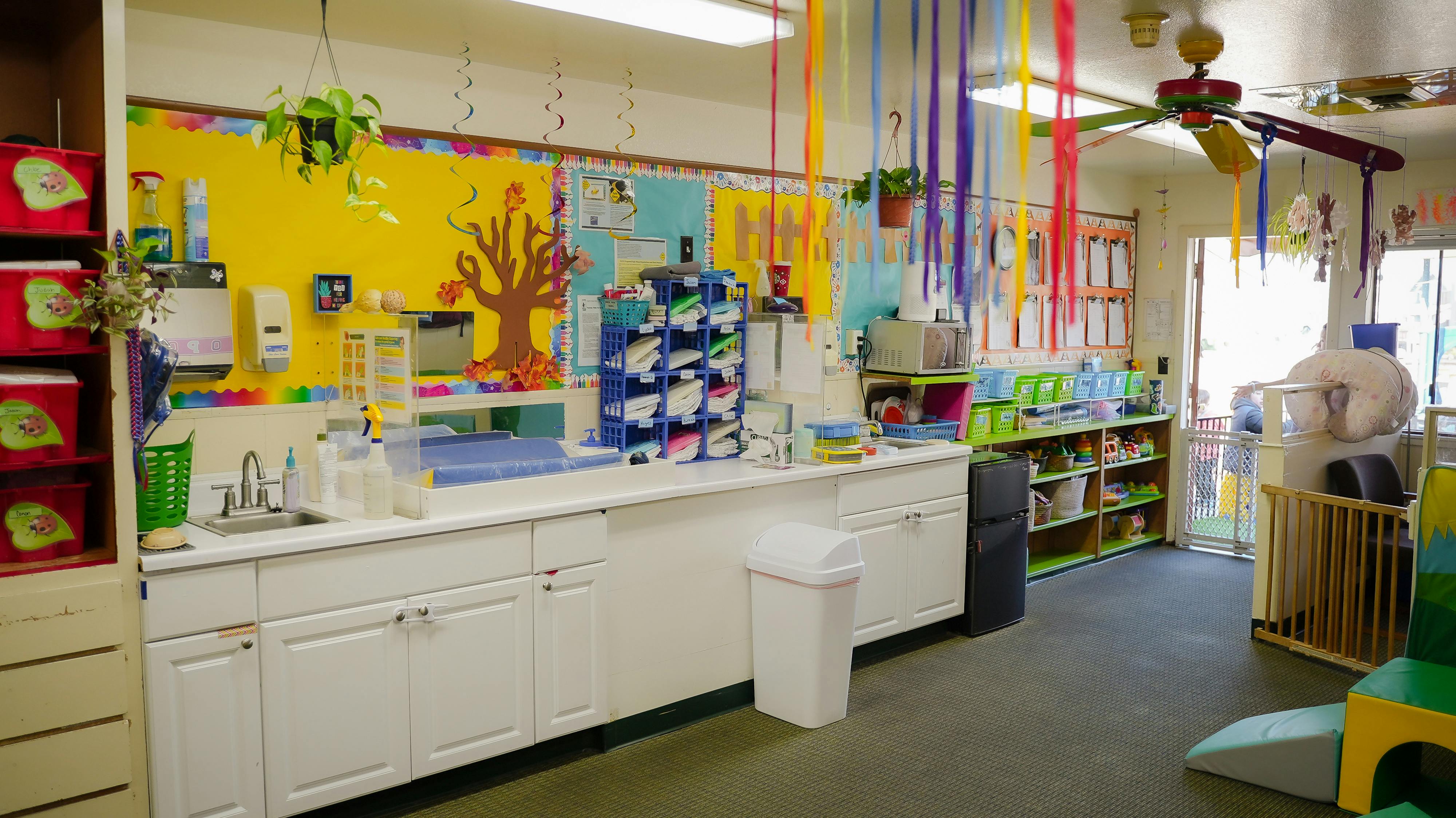 Classroom interior with changing station and storage shelves