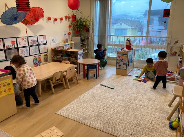 Several children playing with toys in a classroom
