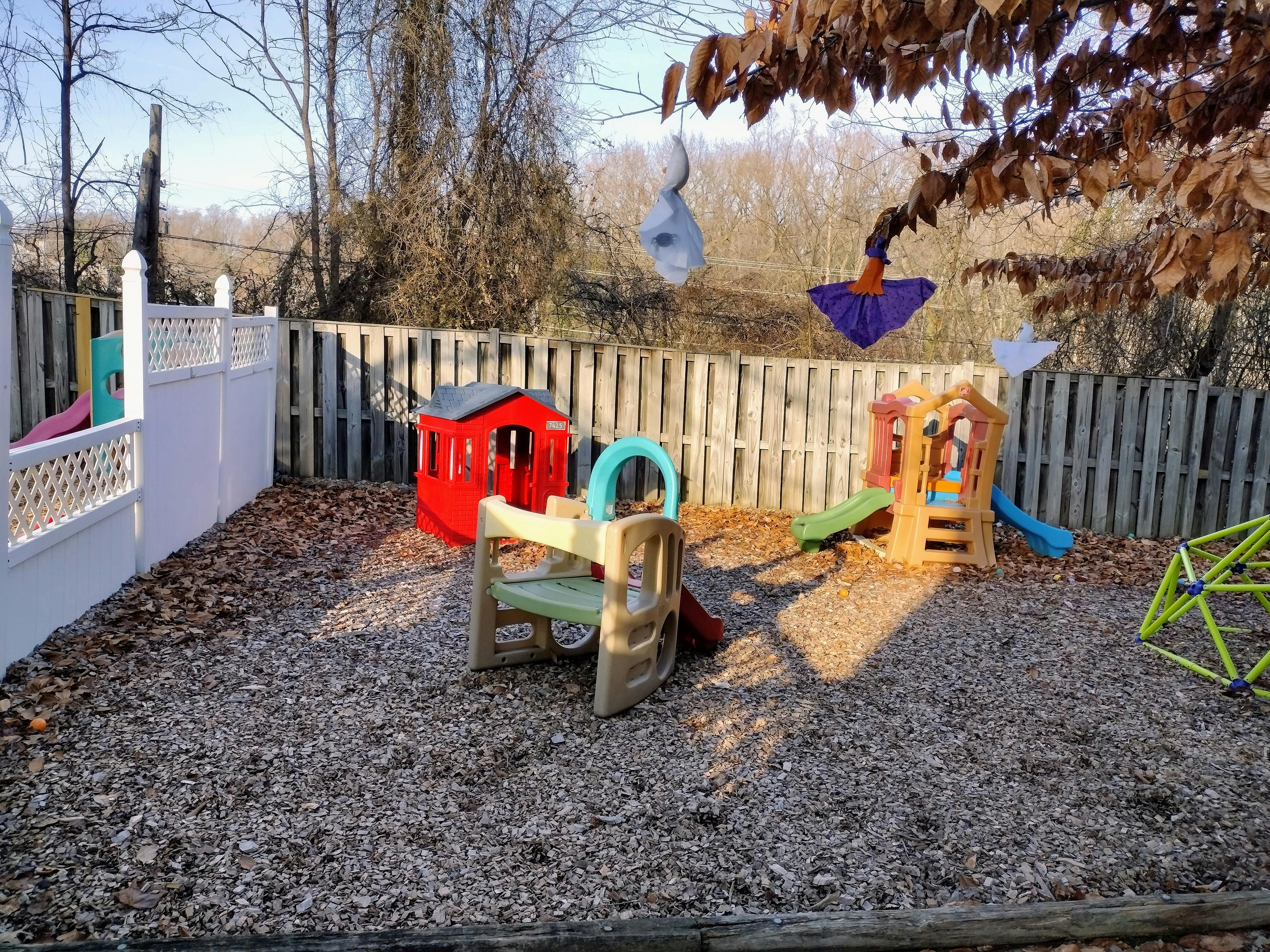 Outdoor play area with playhouses and slides on wood chips