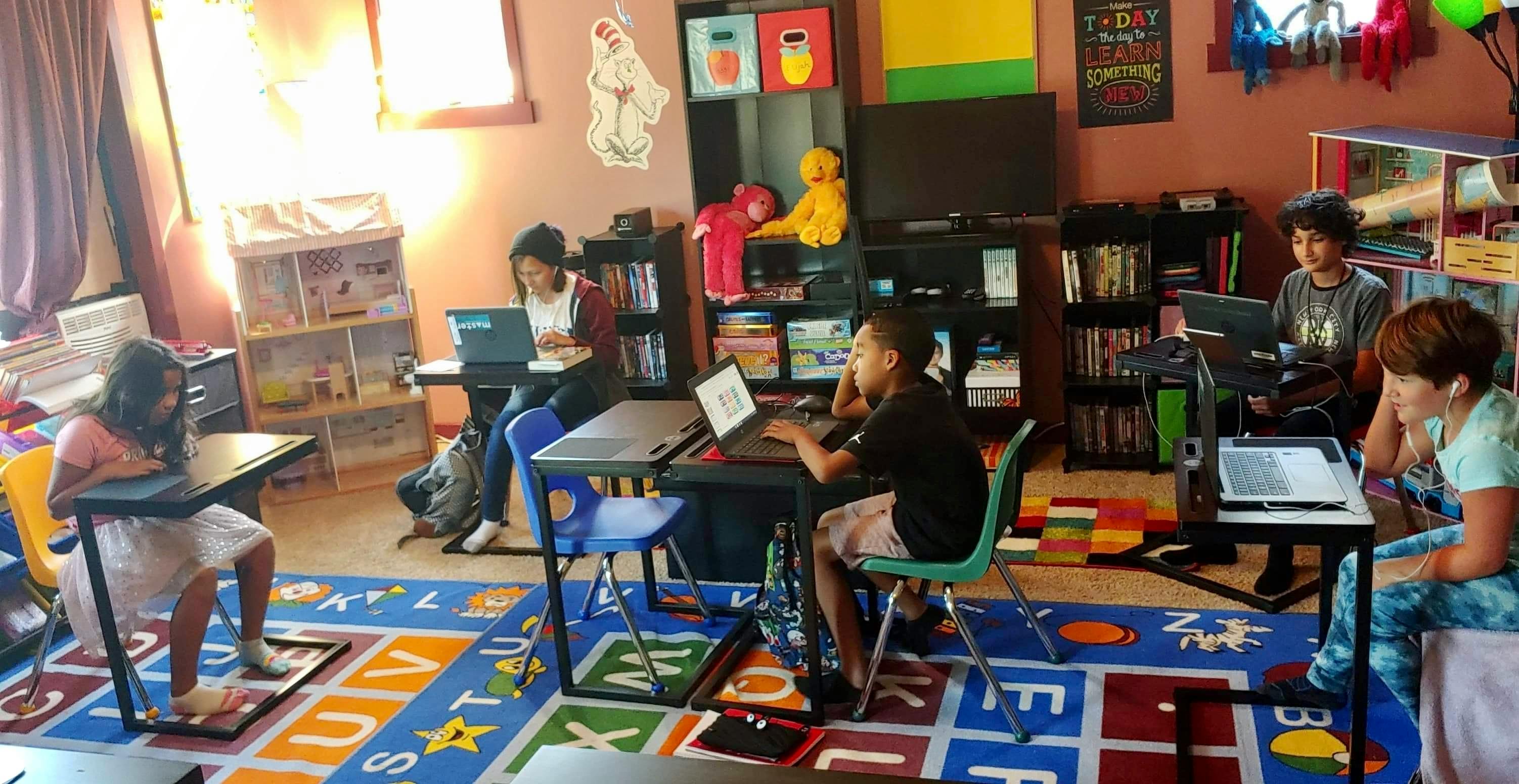Children working on laptops in a classroom
