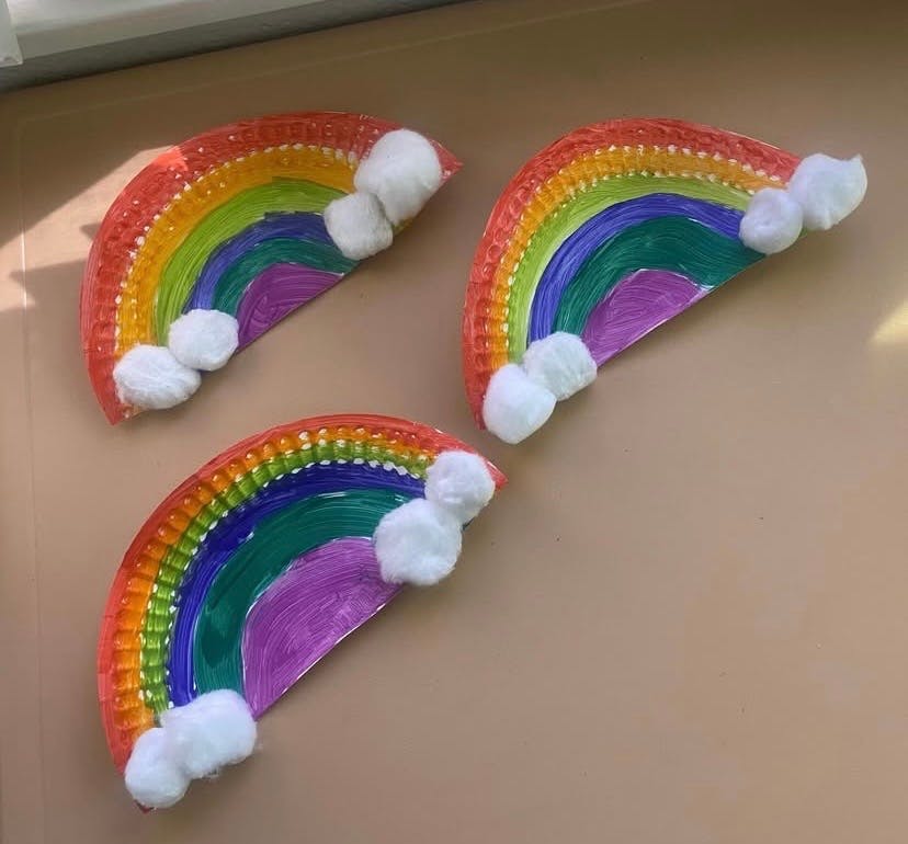 Three paper plate rainbows with cotton ball clouds