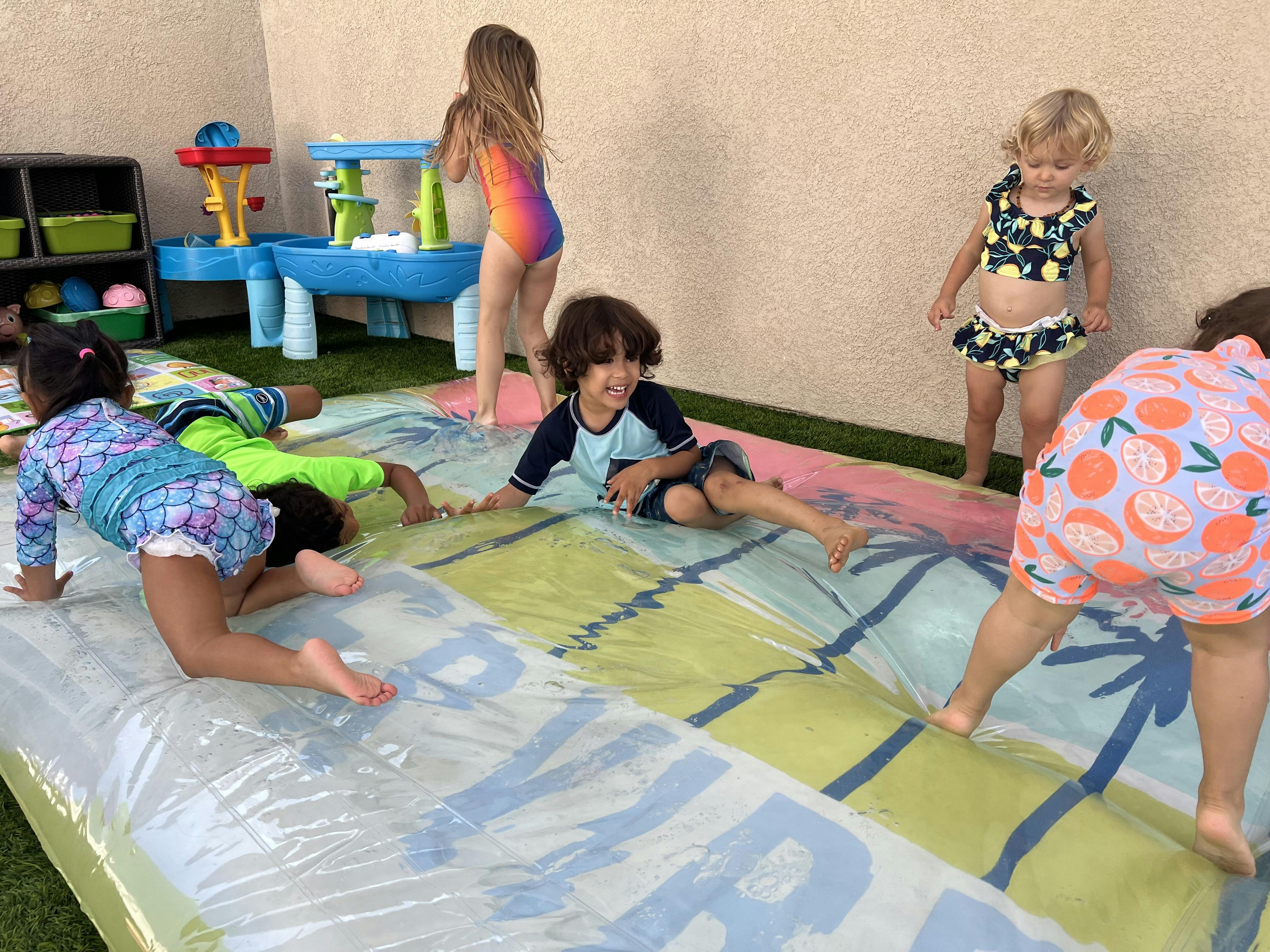 Children playing on a slip and slide