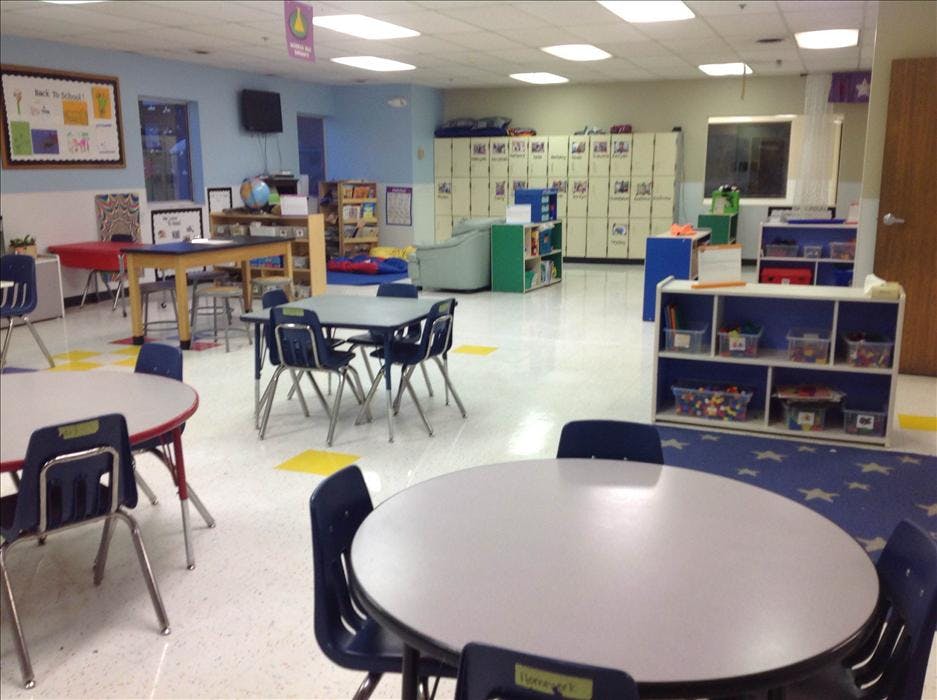 Empty classroom with small tables and chairs