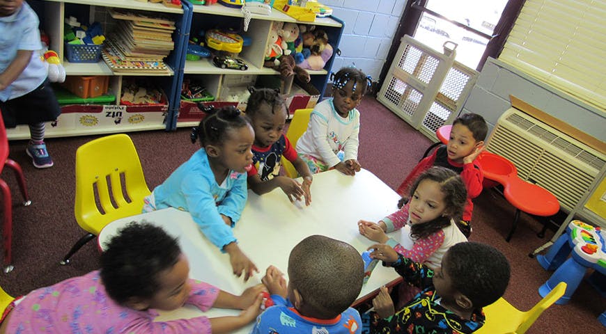 Children sitting around a table in a classroom