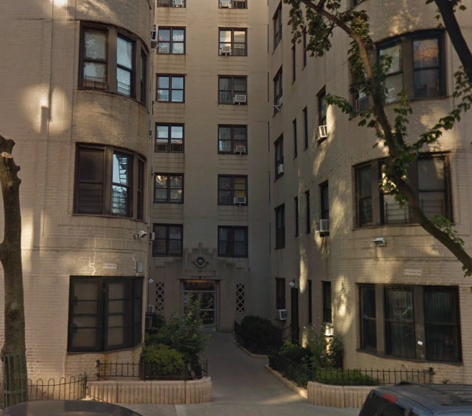 Exterior of a multi-story building with many windows and a central entrance