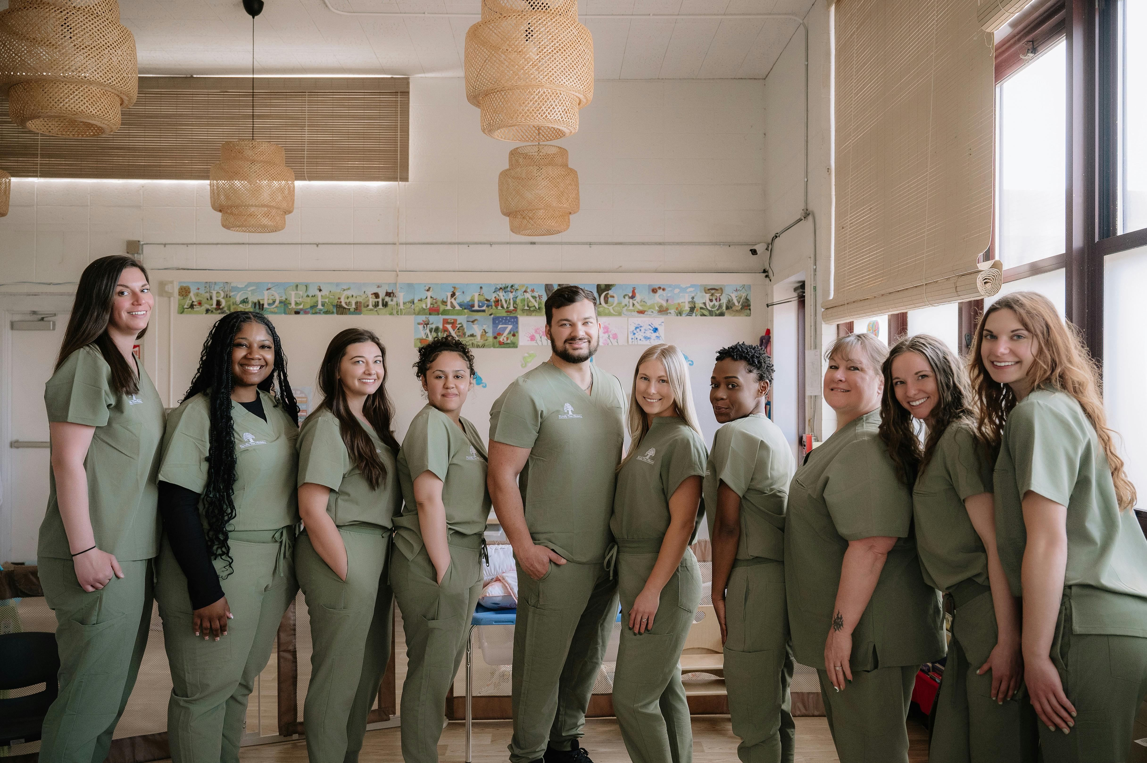 Group of people in green scrubs standing together