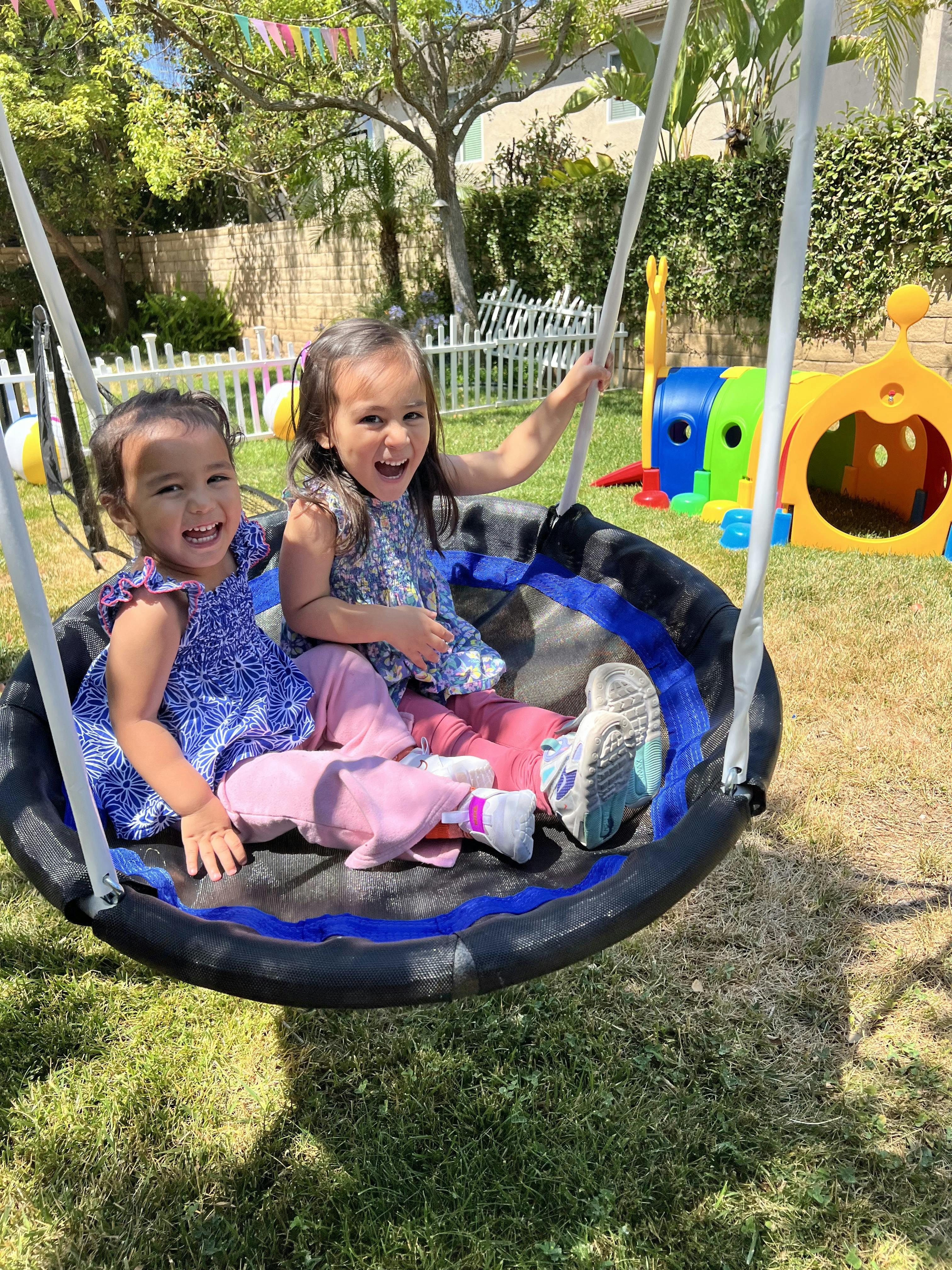 Two children sitting in a swing