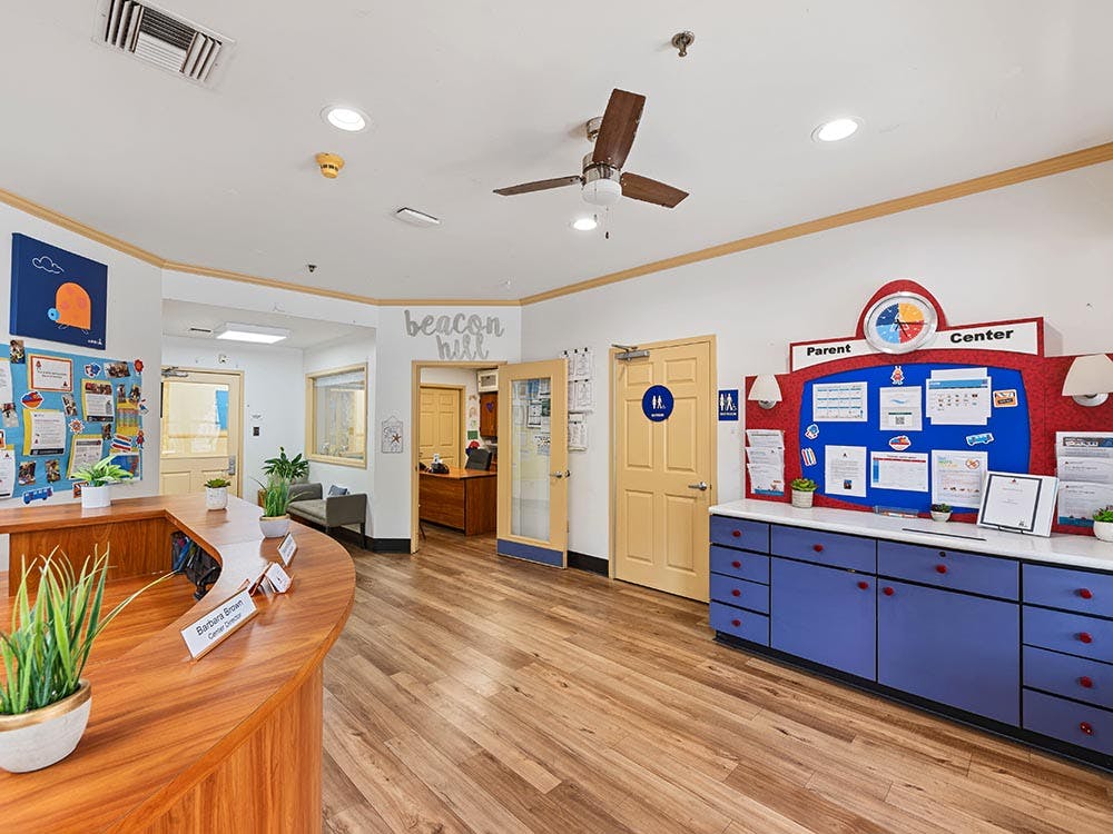 Reception area of a learning center with "Beacon Hill" on the wall