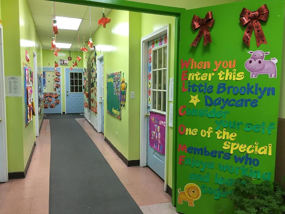Hallway with lime green walls and a green sign with text and animal cutouts