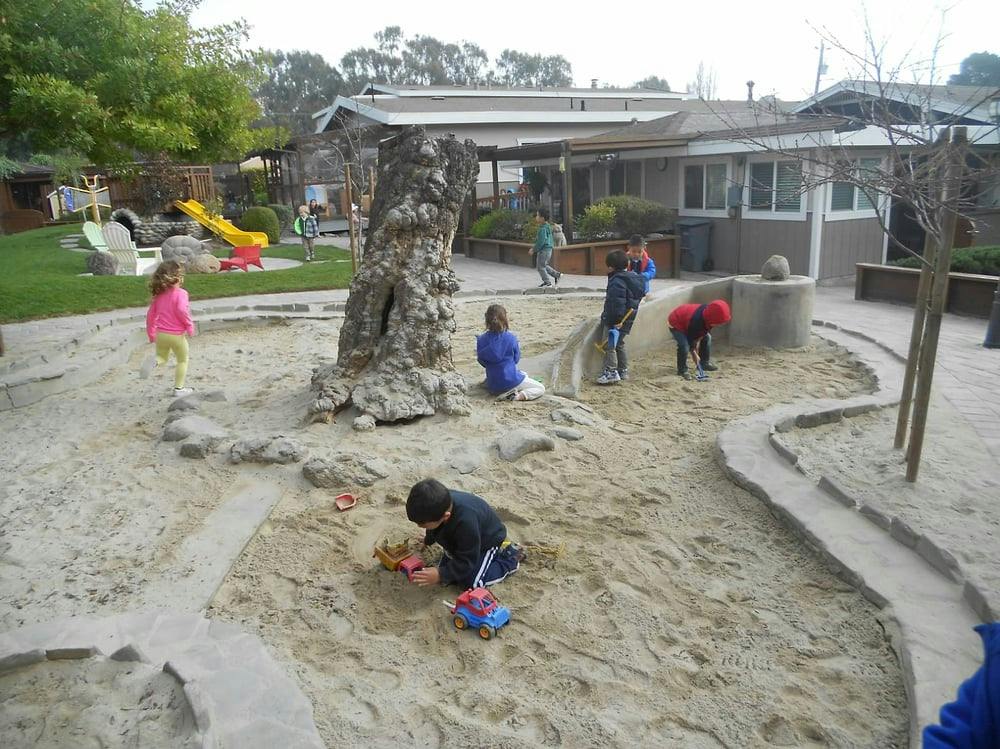 Children playing in a large sandbox