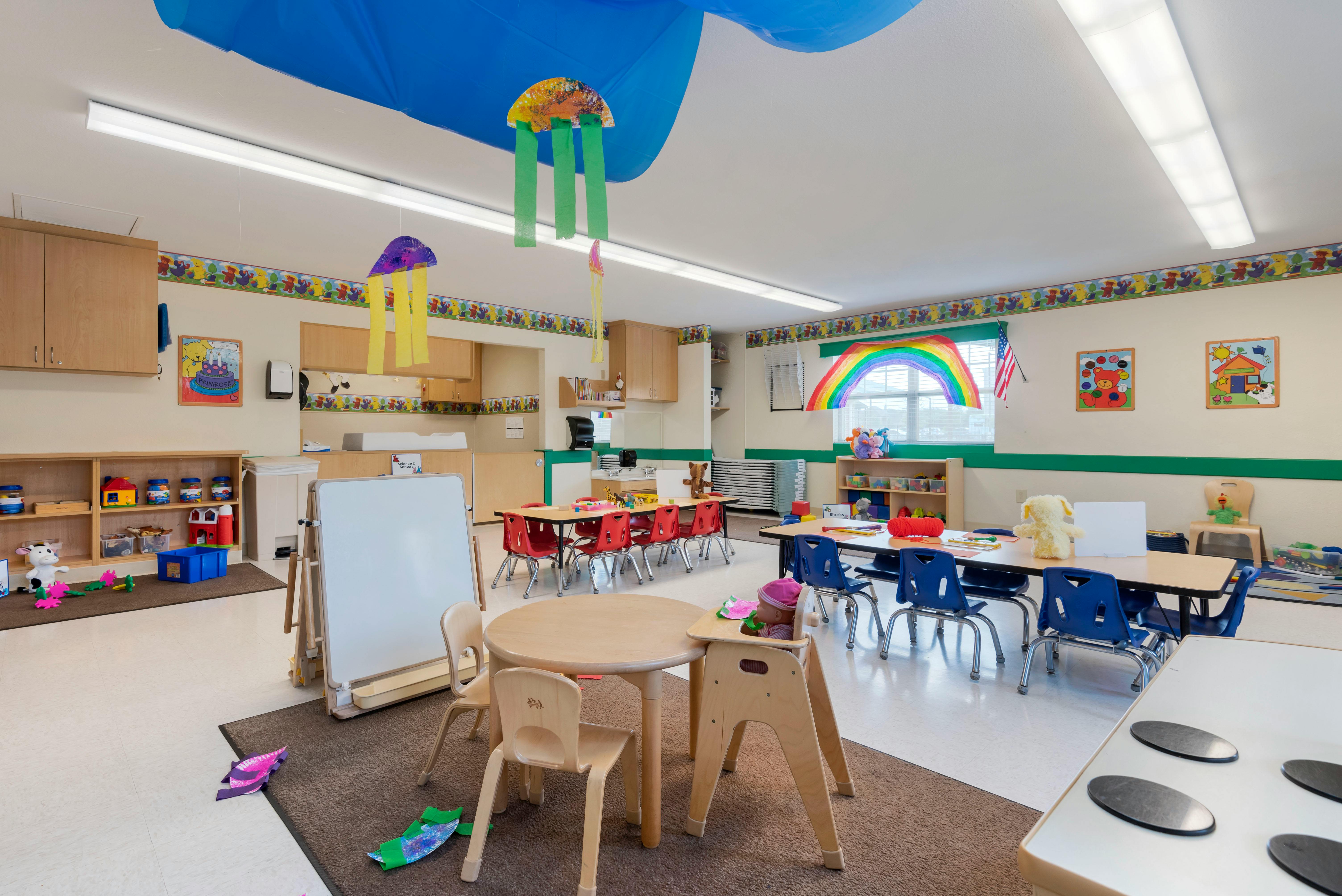 children's classroom with small tables, chairs, and decorations