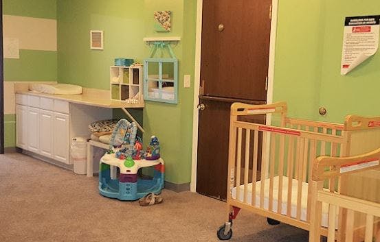 Nursery room with cribs and changing table