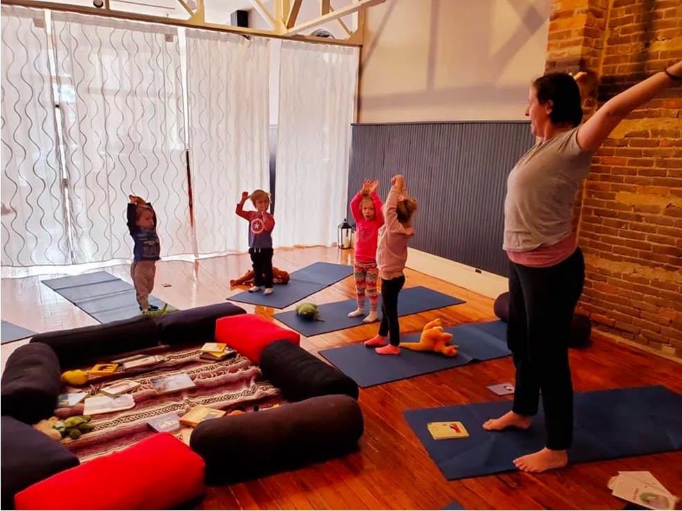 Person leading children in a yoga class