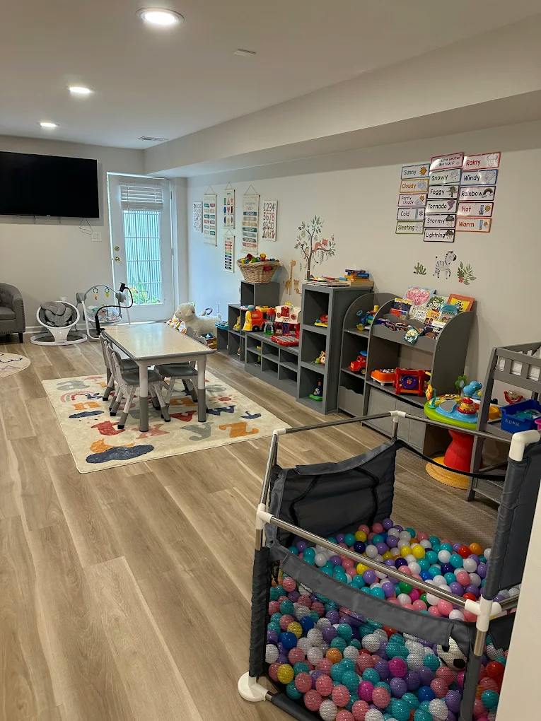 Playroom with a ball pit, activity table, and educational wall charts
