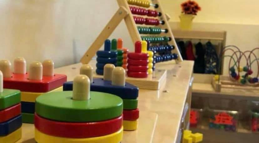 Colorful stacking toys and an abacus in a classroom