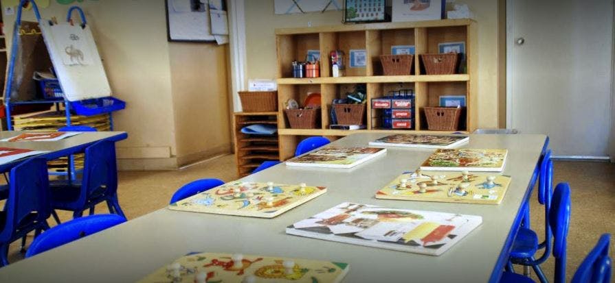 Classroom with tables, chairs, and puzzles on the tables