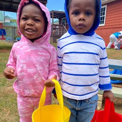Two children holding baskets outdoors