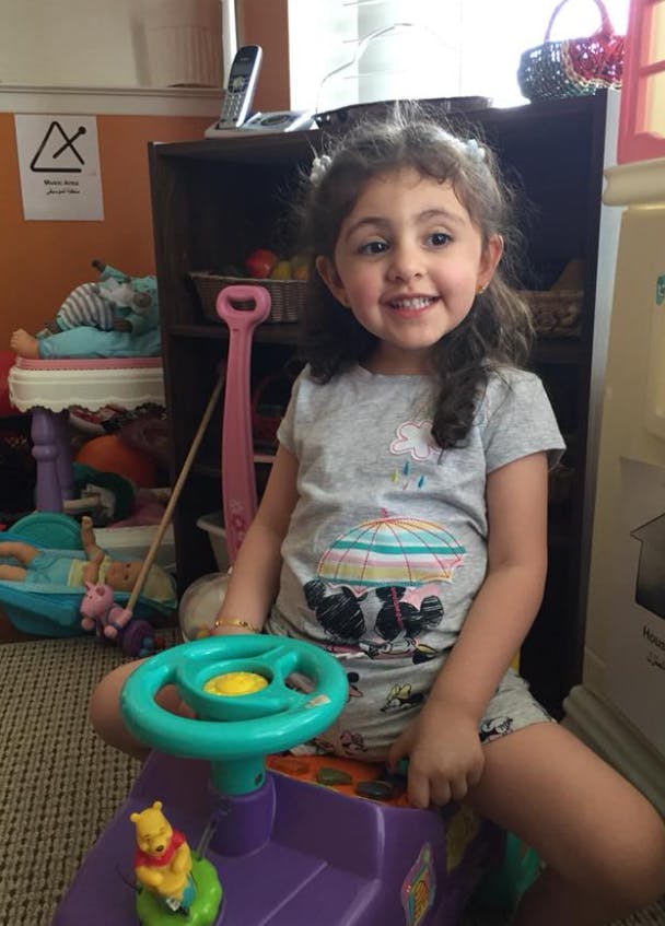 Child sitting on a toy ride-on car