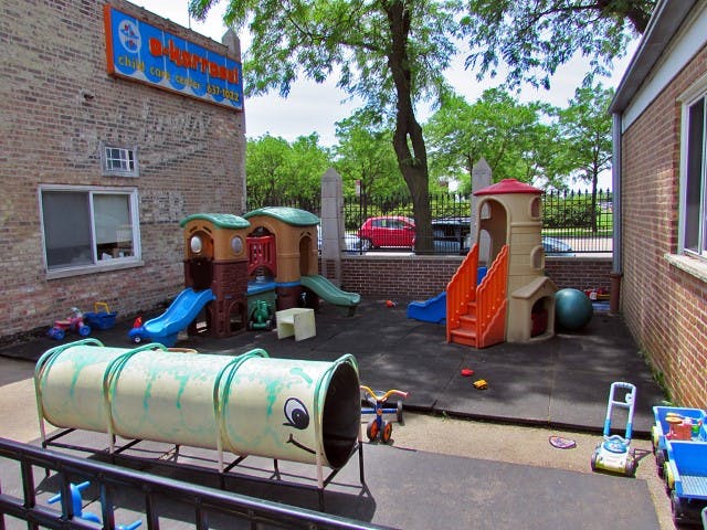 Outdoor playground with slides, playhouses, and a tunnel