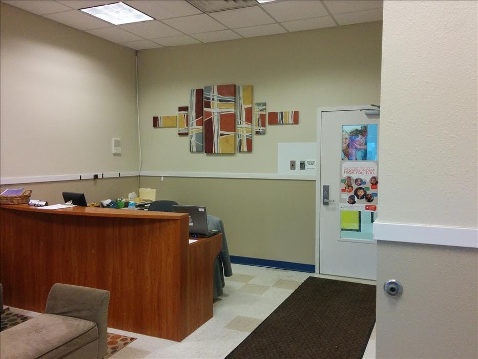 Reception desk with laptops in a waiting area