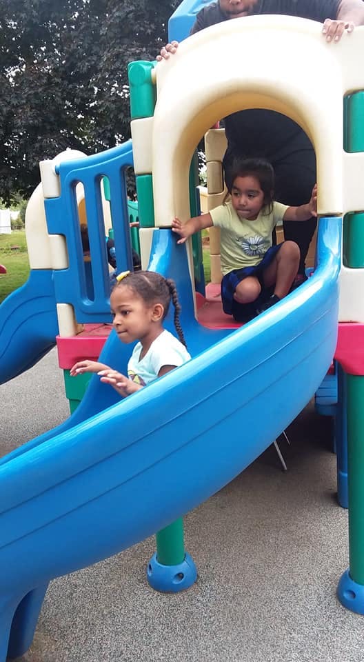 Two children on a playground slide