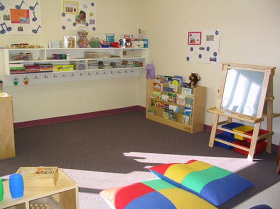 Empty classroom with shelves, books, and an easel