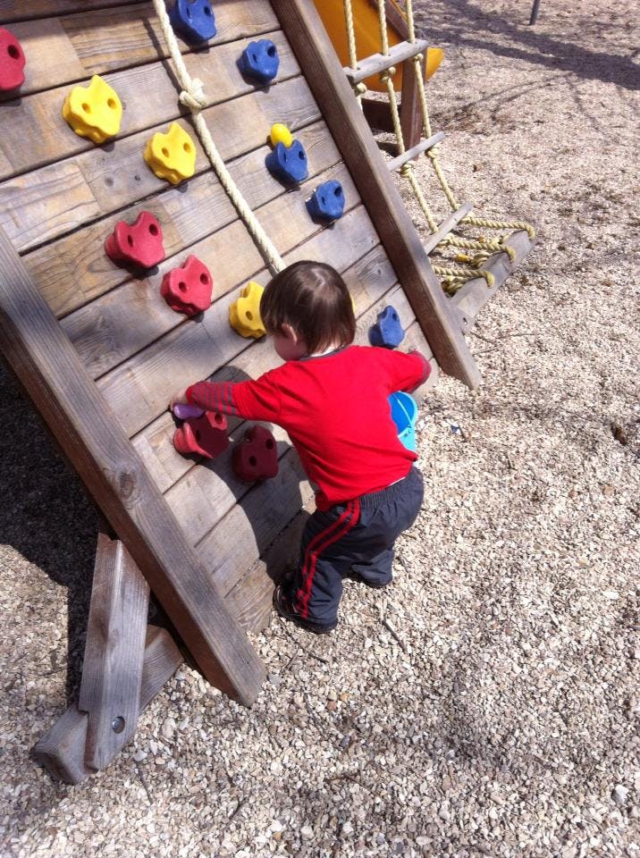 Child on a climbing wall at a playground