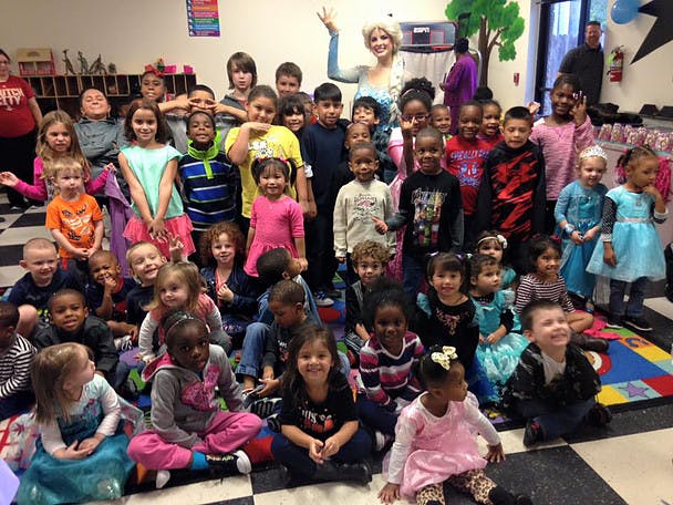 Large group of children and adults posing for a photo indoors